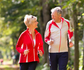 Man and woman jogging in the woods.