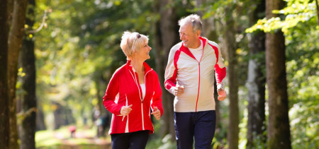 Man and woman jogging in the woods.