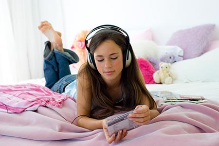 Teenage girl listening to music on her headphones.