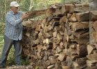 Man outside stacking fire wood