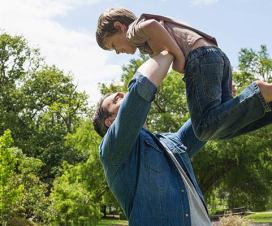 Dad lifting boy up in the air
