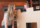 Mom playing with son in cardboard box