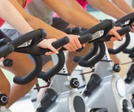 close up of people biking on stationary bikes at a gym