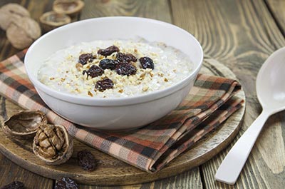 Bowl of oatmeal with raisins and walnuts – healthy eating