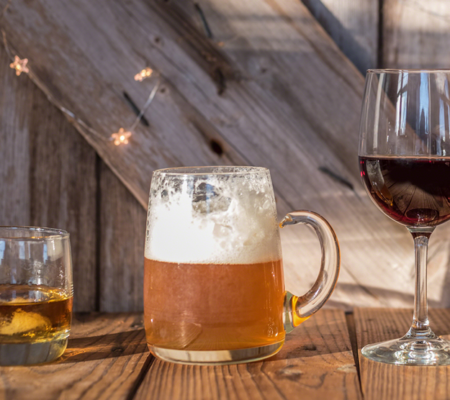 cups of beer, wine and alcohol showing a drinking problem with alcoholism and binge drinking