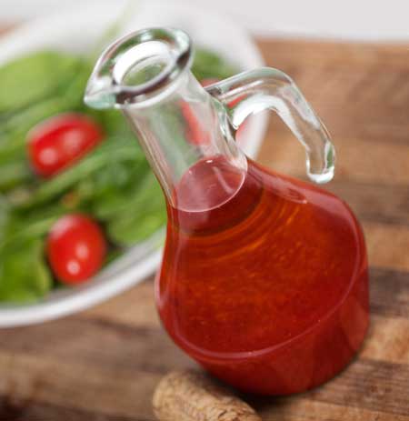 bottle of homemade tangy dressing with a salad