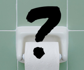 Toilet paper roll on bathroom wall with question mark