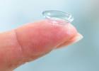 Woman holding contact lens on her finger