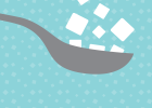 Illustration of spoon filled with sugar granules