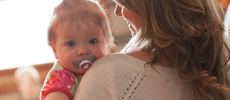 Cute baby girl in mommy's arms