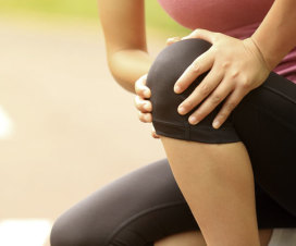 close up of woman holding knee