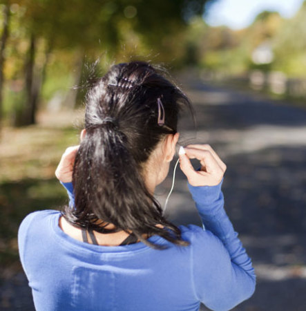 Back view of woman wearing earbuds
