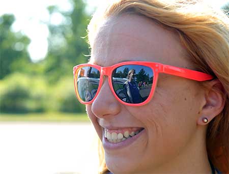 Smiling woman wearing bright orange shades