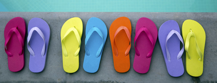 pairs of flip flops beside a pool