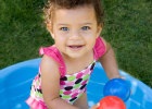 smiling girl in a kiddie pool