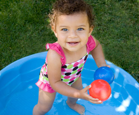 girl standing in a kiddie pool