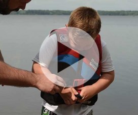 Video image of boy fitting a lifejacket for safety