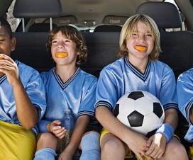 kids eating oranges as a snack at a soccer game
