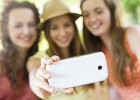 Girls taking selfie with smartphone