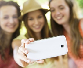 Girls taking selfie with smartphone