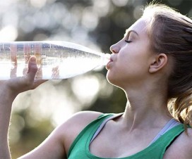 Teen girl drinking water from a bottle