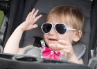 Little girl in stroller with sunglasses