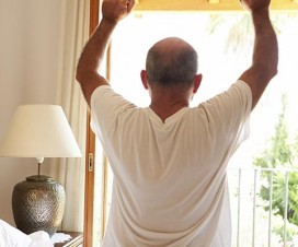 Middle-aged man stretching his back in the morning