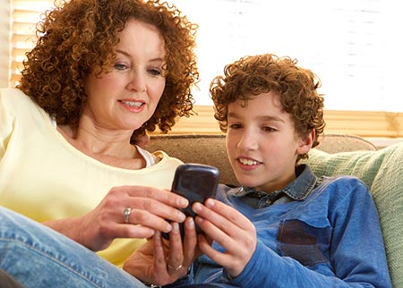 Mom giving son a cell phone