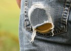 Can of chewing tobacco worn through a back pants pocket