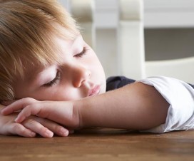 Young boy sleeping at the breakfast table - adjusting sleep schedule for daylight saving time