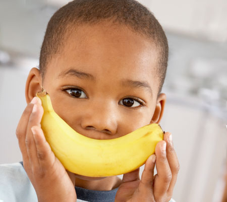 young body holding a banana as a smile