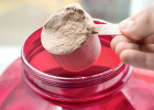Person scooping protein powder