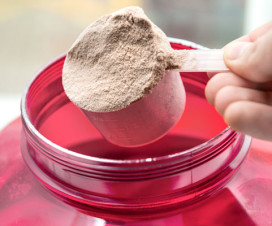 Person scooping protein powder