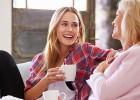 Two women talking over a cup of coffee - PMS, PMDD: You don’t have to suffer with symptoms