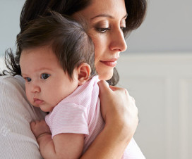 Mother holding baby in close embrace - Dealing with postpartum depression