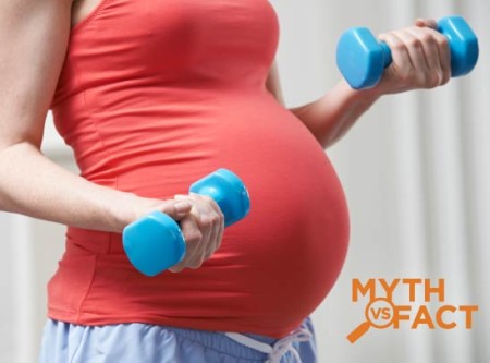Pregnant woman exercising with free weights - Myth vs facts: Pregnancy and exercise