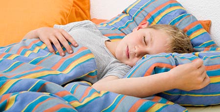 Young boy sleeping - Managing voiding problems