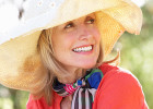 Woman with large sun hat sitting outside - Concerns about sun exposure after cancer