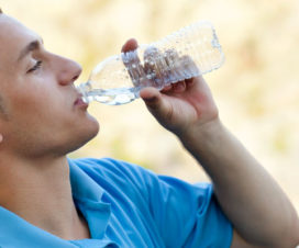 Male hiker drinking water