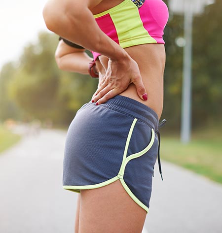 Stopped runner holding lower back - Sciatica