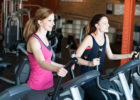 two women on bike training in a gym