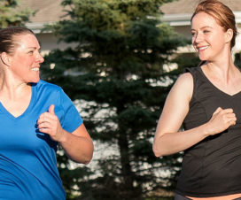 Two women enjoying each other's company as they run outside - Reasons to exercise