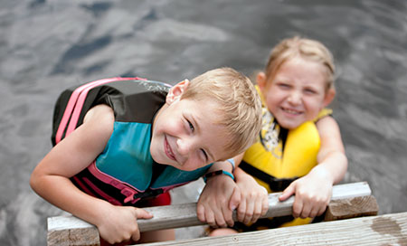 Two kids, climbing up a dock after swimming – Swimmer's ear