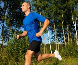 Man jogging outside on trail – Can exercise reduce cancer risk?