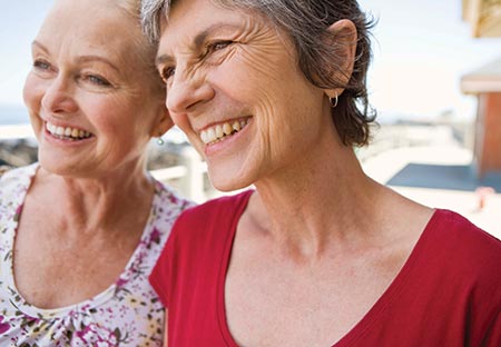 Two women smiling as they pose for a photo - How menopause can affect your health