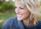Woman sitting outside smiling - Mammography technology developments