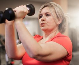 Woman lifting free weights - Exercising and eating right, but not losing weight