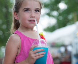 Girl with a slush drink at the fair - Sugar intake guidelines