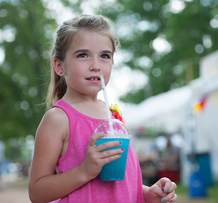 Girl with a slush drink at the fair - Sugar intake guidelines