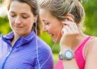 Two women listening to music as they get ready to exercise - Behaviors to beat depression